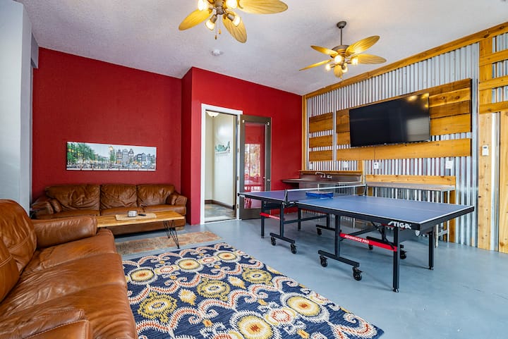 Main floor hang out room. 65 inch tv. Professional ping pong table. Leads out to back deck on river.