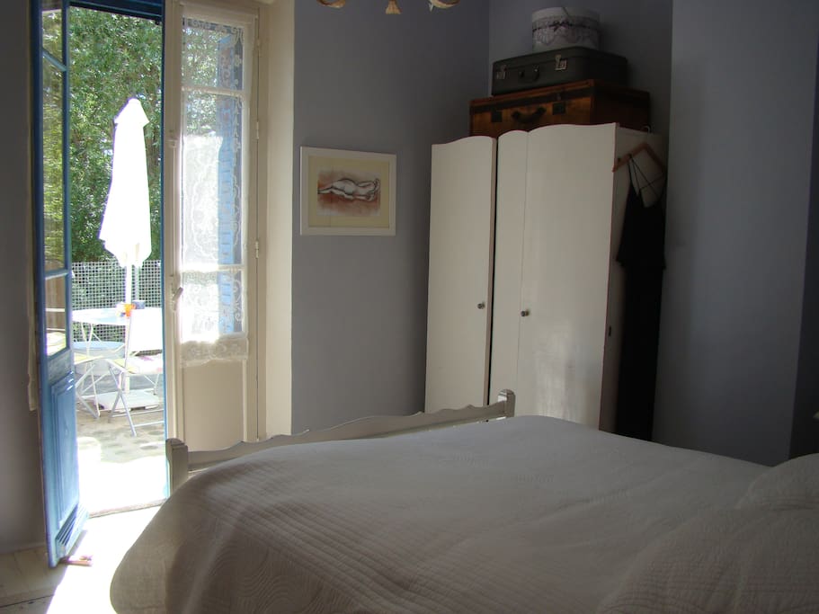 Master bedroom with doors opening onto upper terrace.