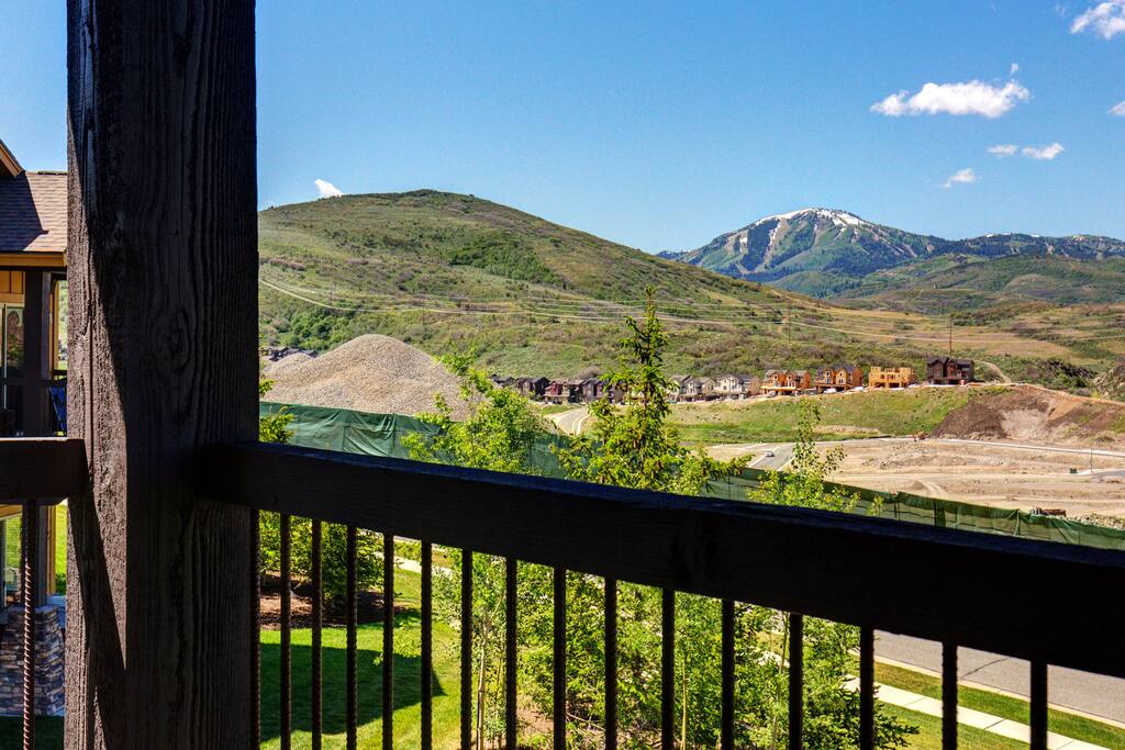The balcony includes a grill and outdoor dining set for 4