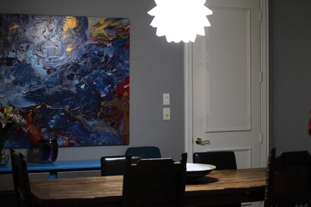 Modern dining room with rustic farm table that seats 8-10.
Idea paint wall, for white boarding, meetings and goal setting.
