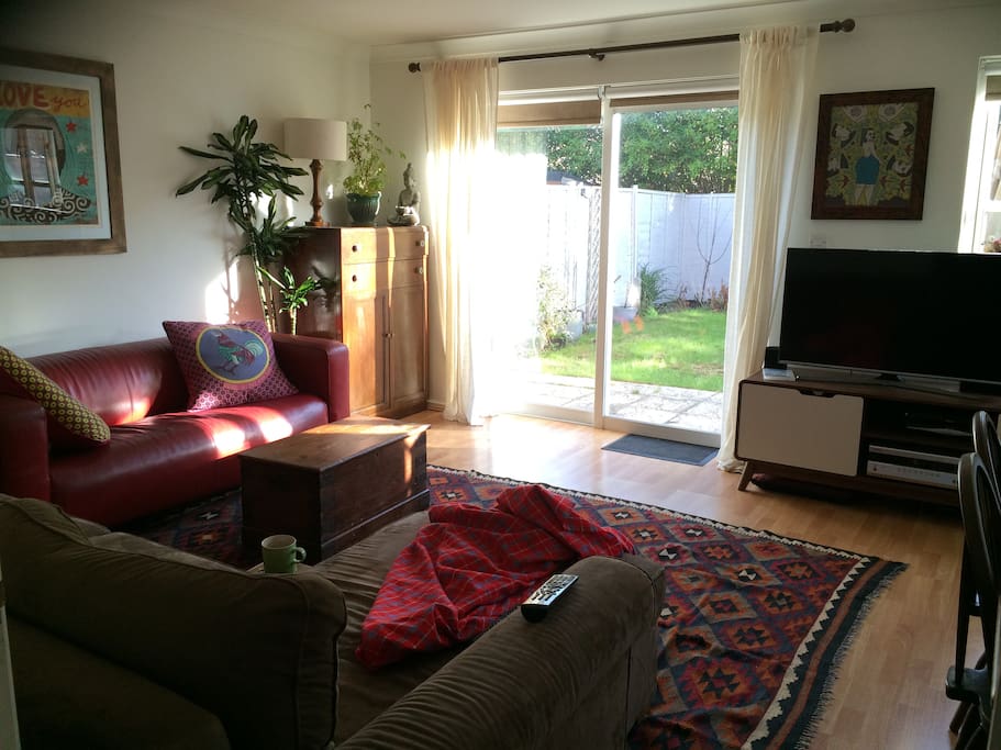 Bright and sunny living room looking onto the garden.