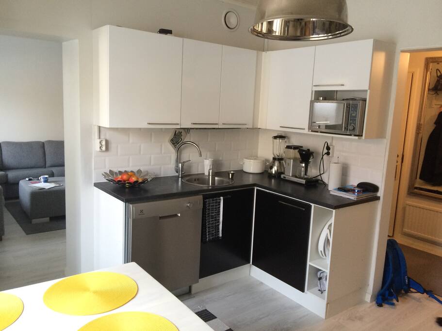 Kitchen with a dish washer and a micro wave.