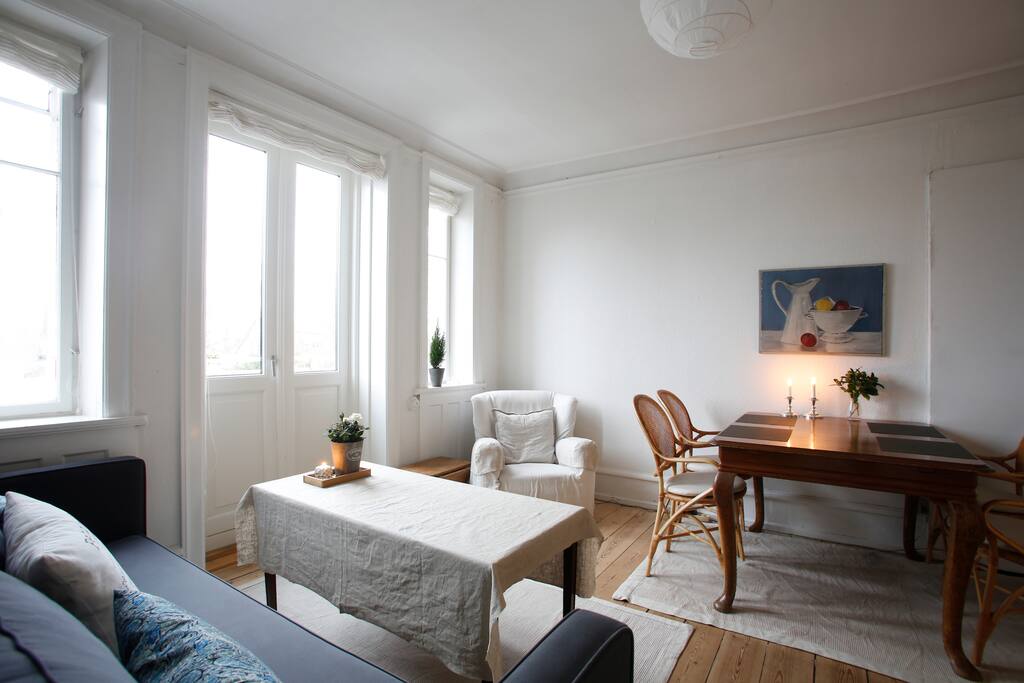 Room 1: Living and dining room with a sofa bed.