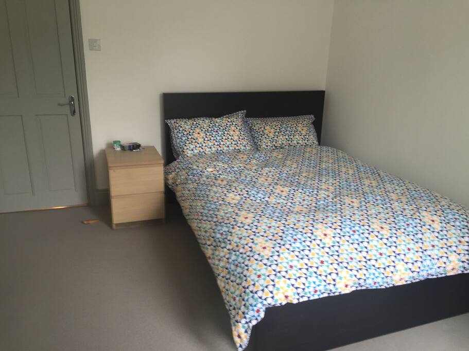 Double bedroom with two large sash windows overlooking terrace.