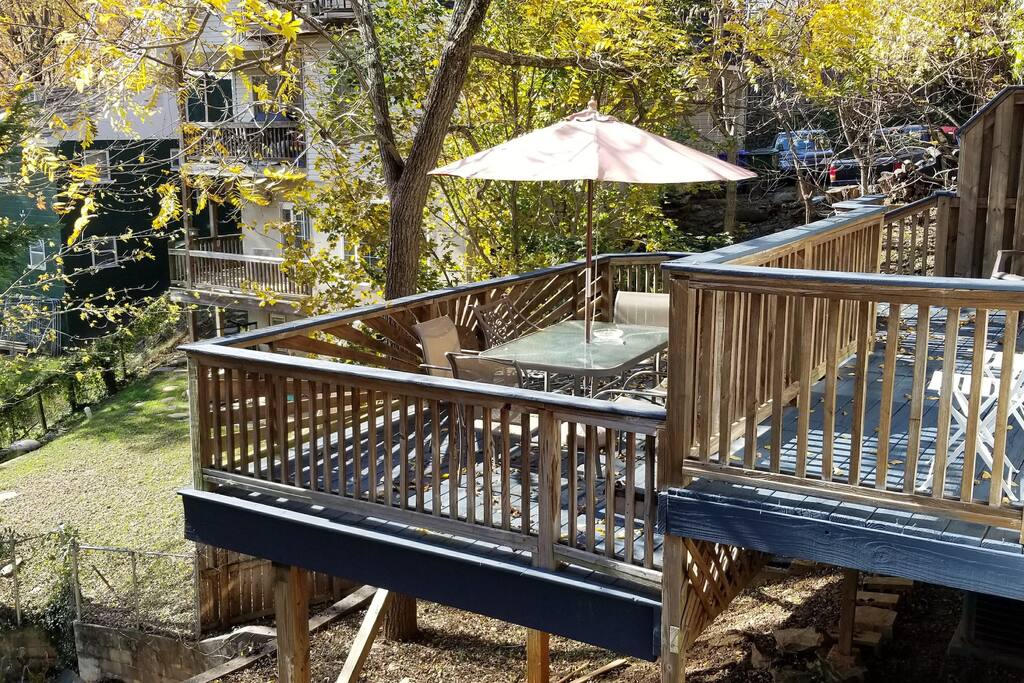 Dual-level back deck provides a great gathering space in the trees, just minutes to downtown