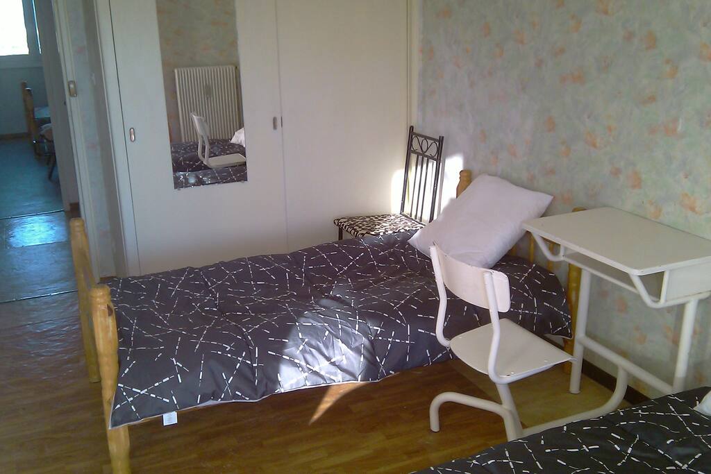 Chambre Sud-Ouest 2 lits, balcon, armoire à glace, table de travail