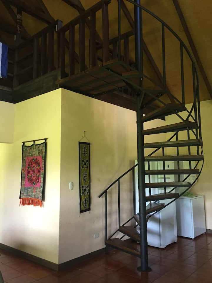 Spiral staircase that leads to loft-the third bedroom.