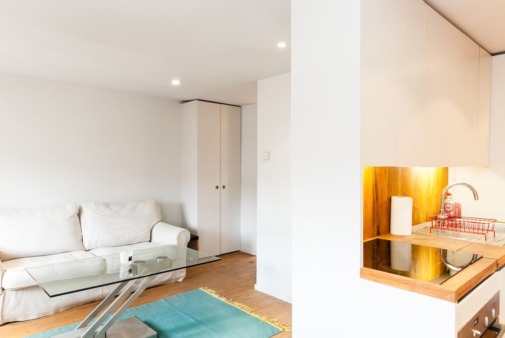 Coffee table converts to dining table with a foot pedal