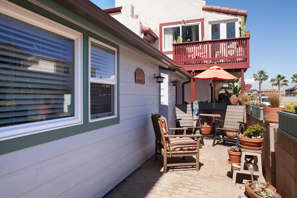 Enjoy a glass of wine on the spacious front porch with views to the beach!