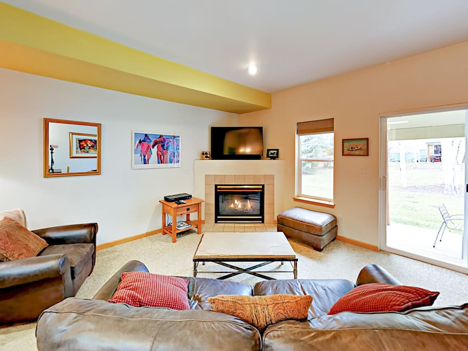 Snuggle up next to the gas fireplace in the sunlit living room.