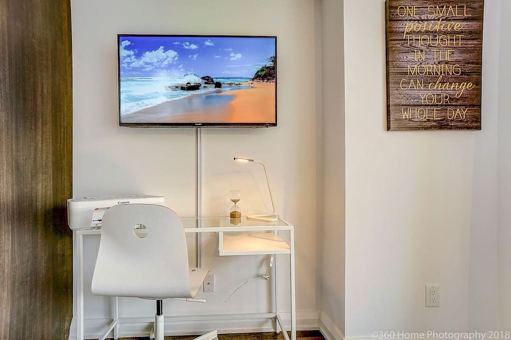 Desk space along a functioning printer. 42" Smart TV