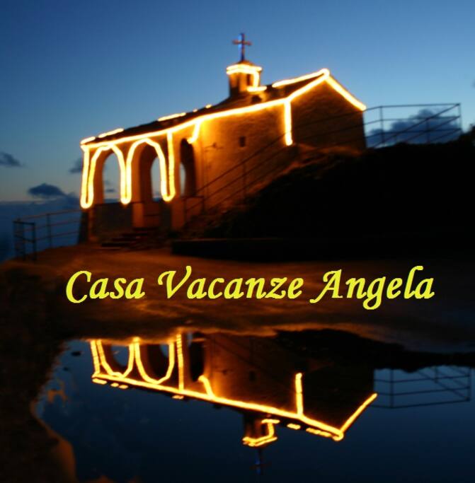 Madonnina della Punta con riflesso su pozzanghera di aqua piovana e dedica