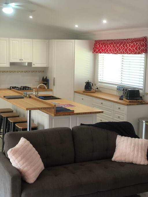 Full kitchen with oven, gas cooktop & dishwasher.