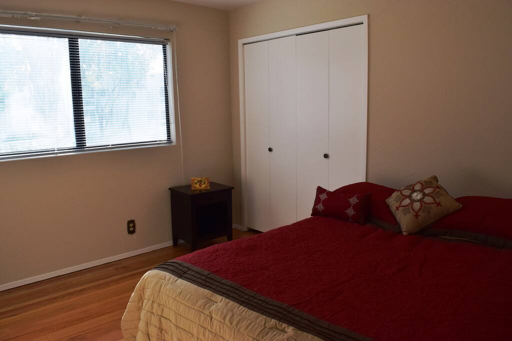 This is the room with a queen sized bed, a closet is also provided. The room is located on the second story of the house.