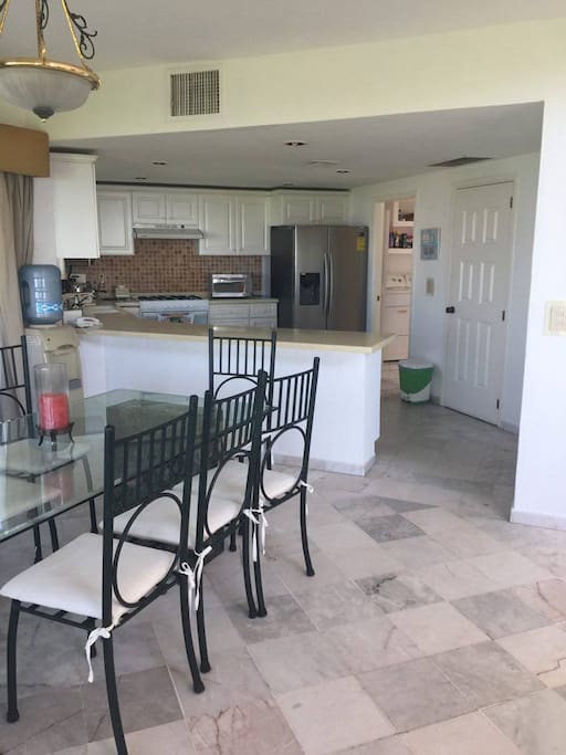 The kitchen has refrigerator, microwave oven, grill, sink, stove, etc