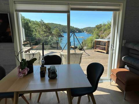 Cabin in the shore of the lake with boat and quay