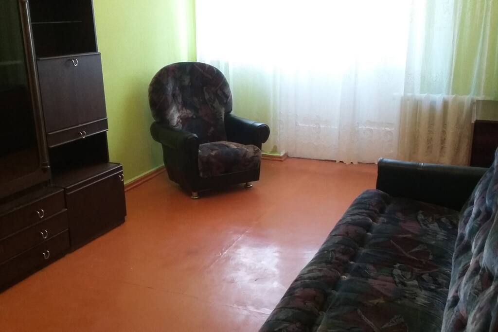 2 bedroom with a sofa, a cupboard, and an armchair