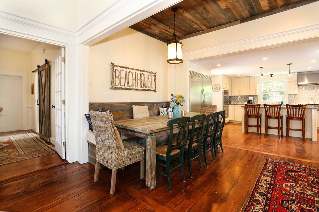 The Great Room viewed from the living area toward the dining and kitchen spaces with TV room beyond on the left