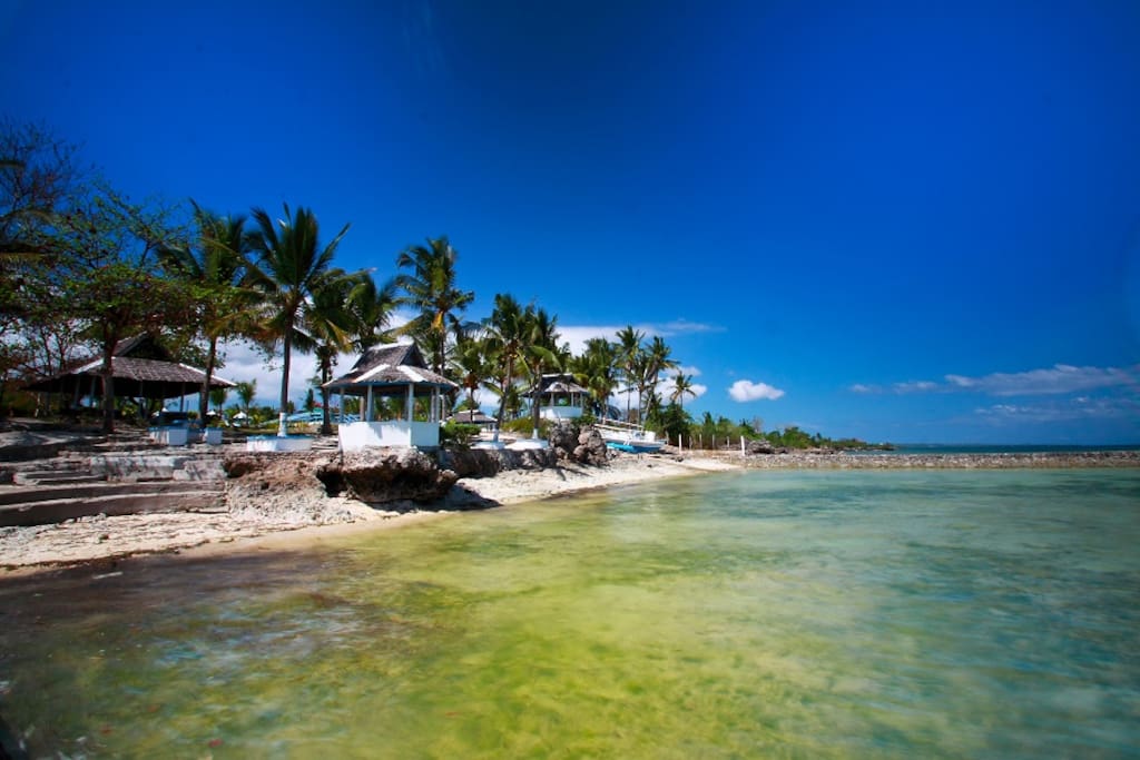 Rocky shore line but sandy bottom sea. Coral Reef off-shore.