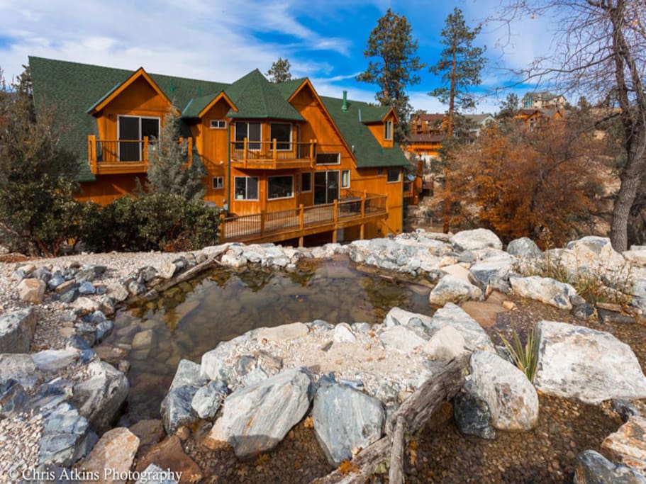 View of the sprawling backyard decks and rock waterfall
