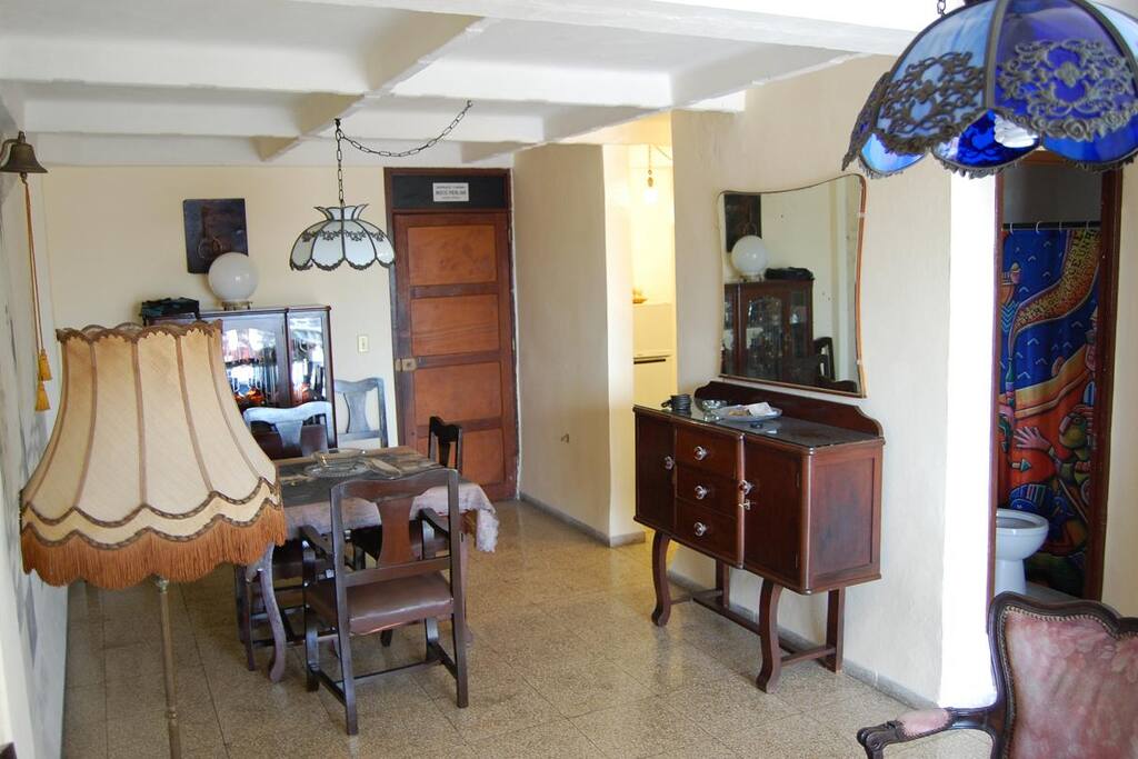 The entrance door, and the dinning room, decorated whit old fashion furniture.
