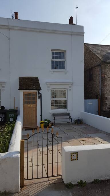 private front garden with seating over looking flint church and muse