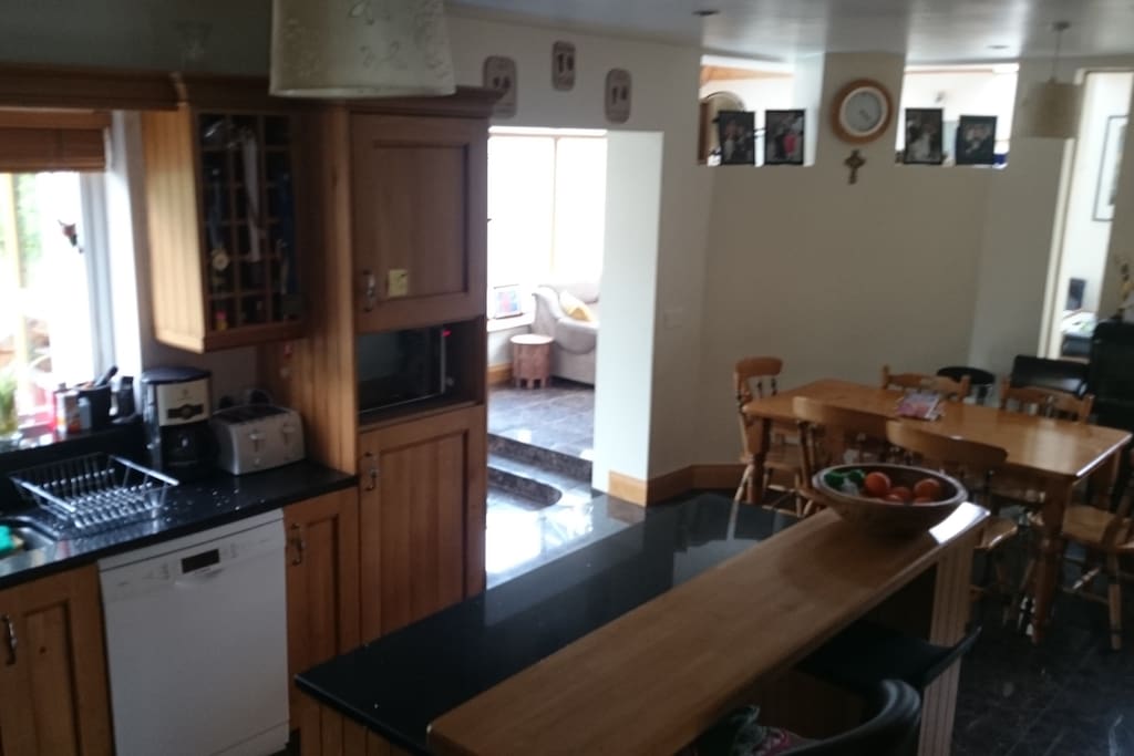 Kitchen area showing breakfast counter and dining table.