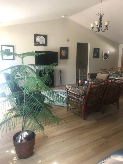 Living room with wood stove, spacious with big bay windows allowing lots of light in.