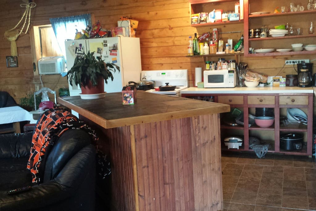 open cupboard kitchen. dishwasher under island.