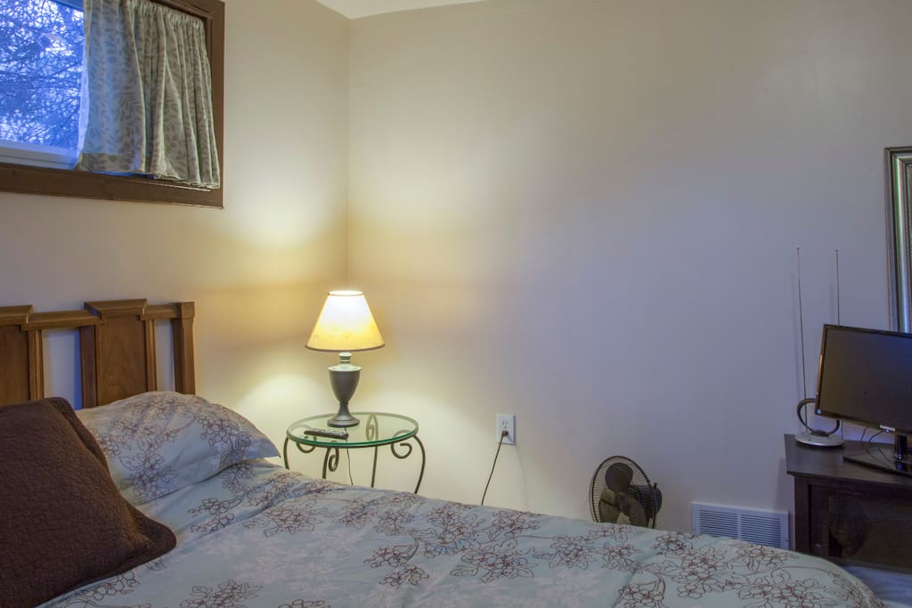 Master Bedroom with KING sized bed, nightstand, flat screen TV, half-mirror and fan if you need it.