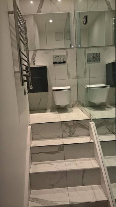 Brand new marble bathroom with heated floor and great lighting