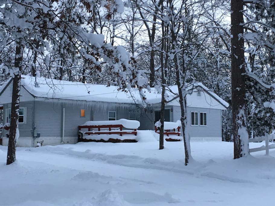 A true winter wonderland. Tucked back off the main roads, our double lot has plenty of room for parking, sleds and OTVs. A covered parking area will keep you sleds or car clean for the morning.
