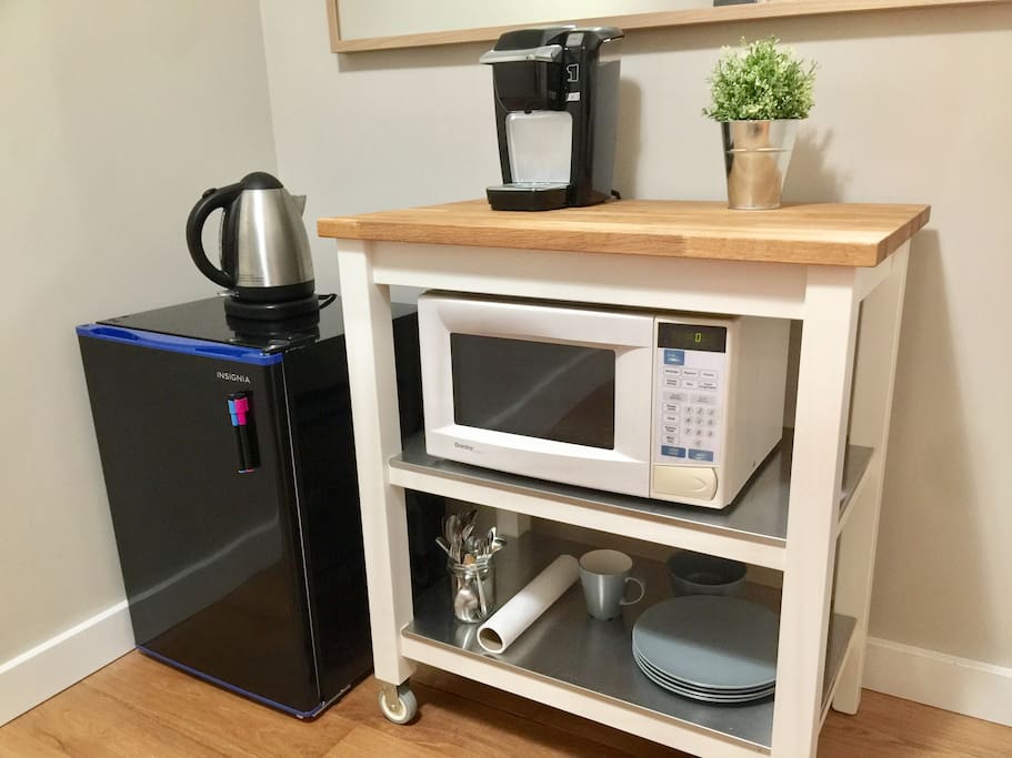 Dishes and cutlery, hot water kettle, and Keurig machine available for use.