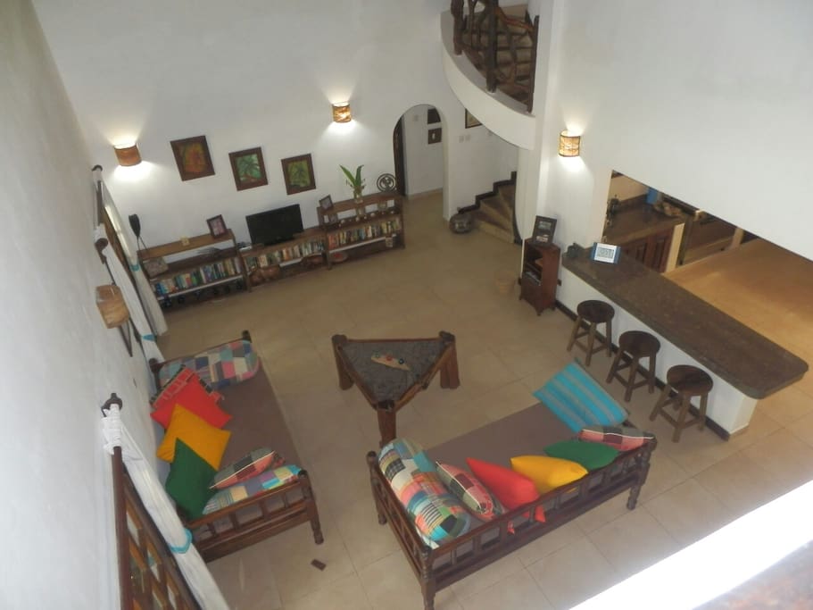 Large open plan lounge and kitchen. Spiral staircase to upstairs area.