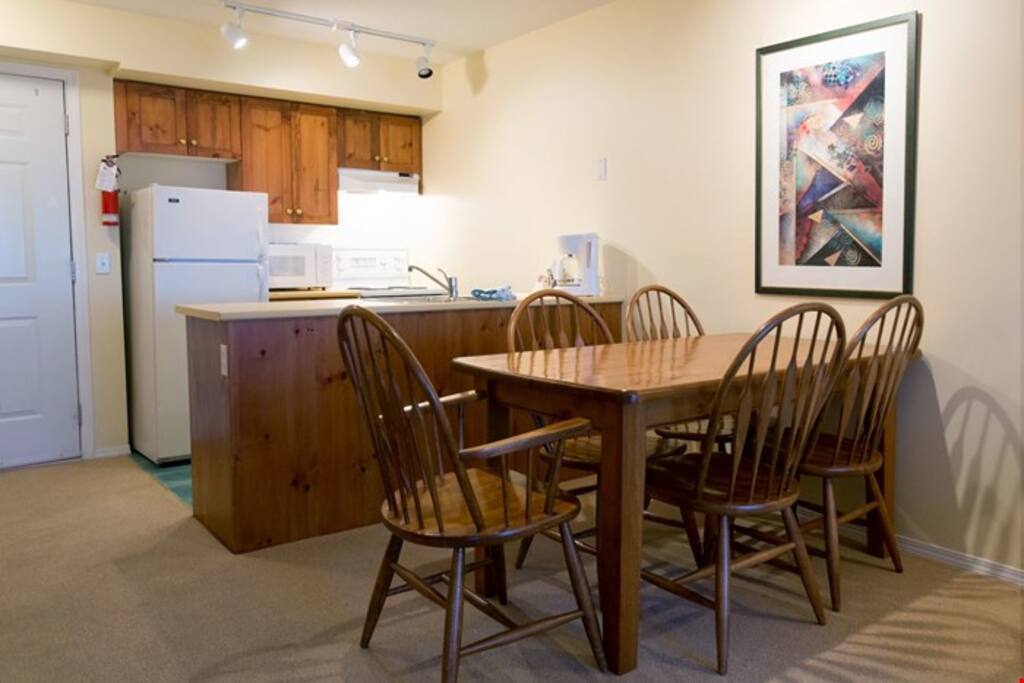 Enjoy meals together at the wooden dining table.