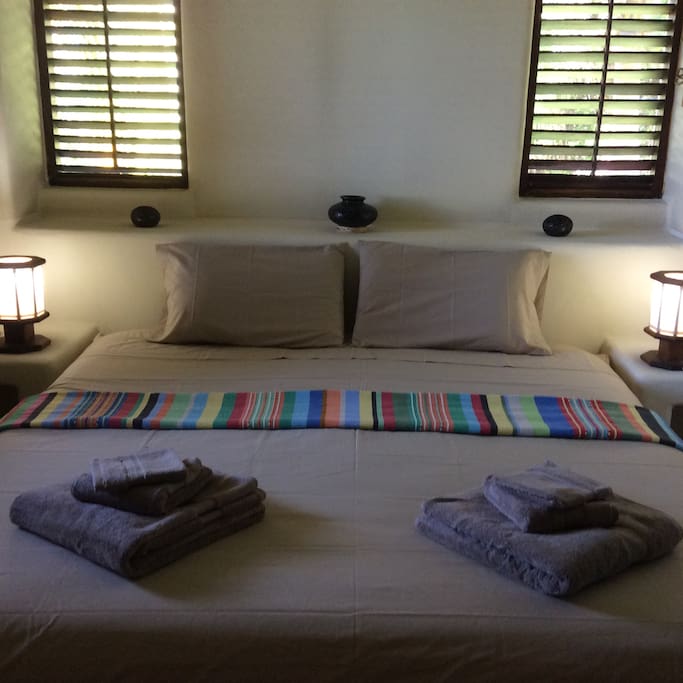 King size bedroom, with bathroom and tv.