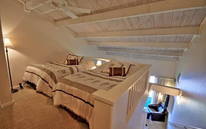 Loft style bedroom with two full beds