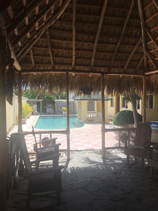Hanging out area with chairs and radio with a view of the pool