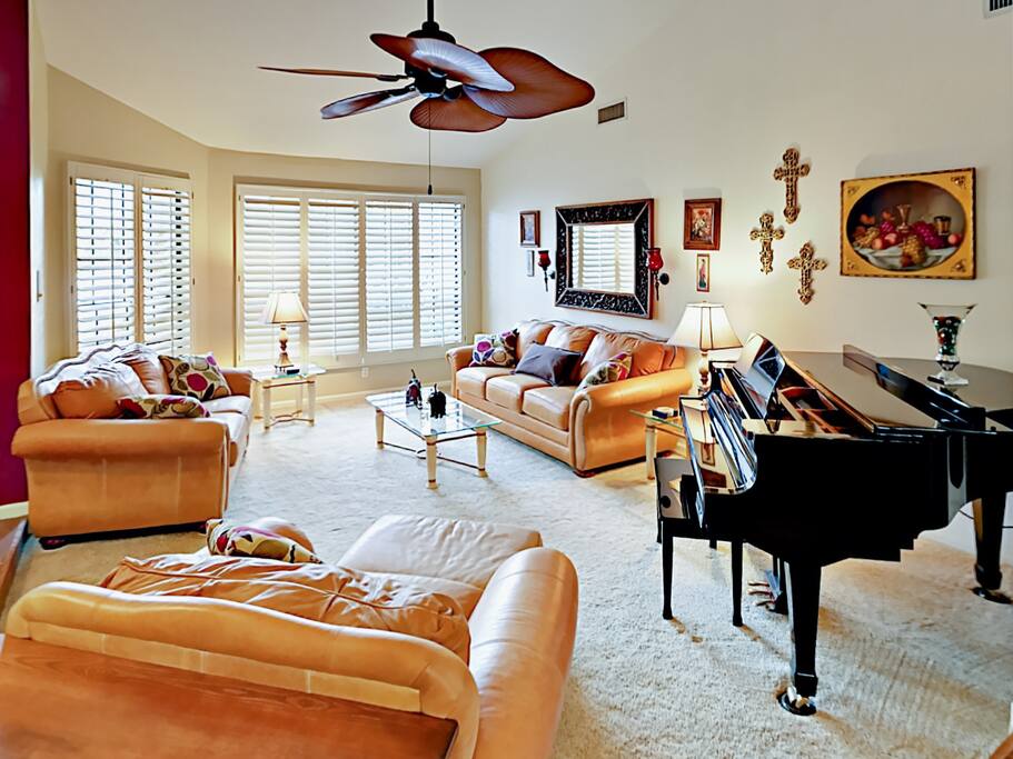 The baby grand piano is surrounded by comfortable seating for in-home concerts!