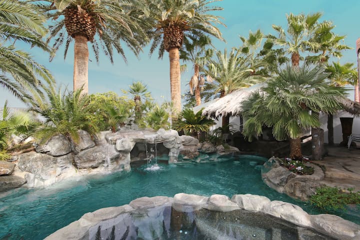 Private pool with grotto and tiki hut.