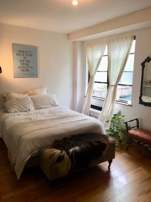 Airy, bright and large bedroom with queen sized bed and big windows flooded with light