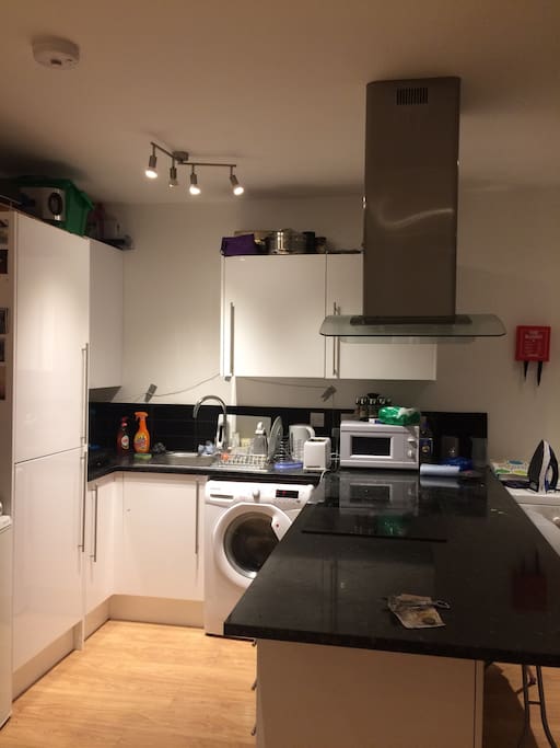 Large open kitchen with washing machine and dryer