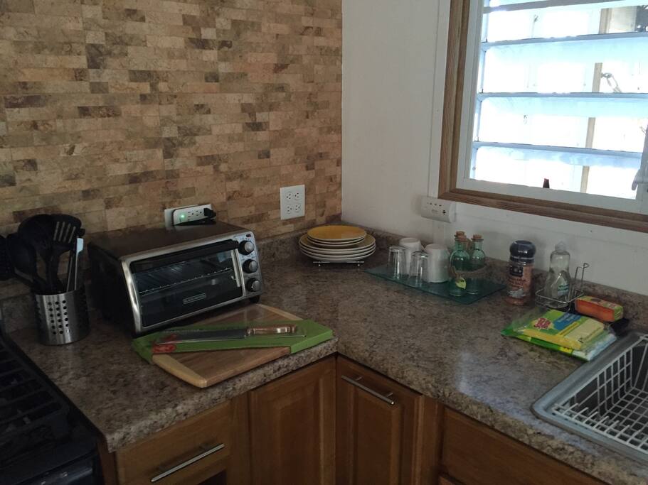 Open space fully equipped kitchen with everything you might need! Stove, oven, microwave, expresso/cappuccino machine, toaster, cookware, plates, cups, utensils for eating and cooking, refrigerator, dining bar with 4 chairs.