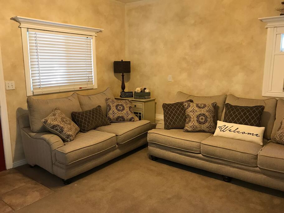 A living room space with deep seating and 50" flat screen TV