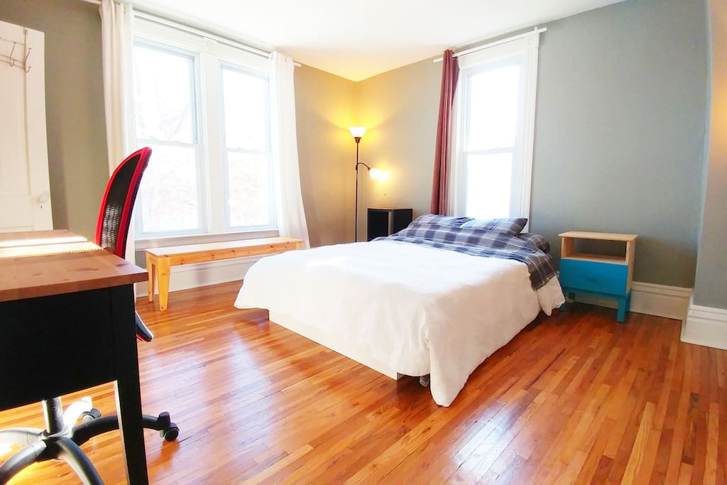 Bright and spacious bedroom with comfortable new queen mattress, large desk and deep walk-in closet with lots of shelving.