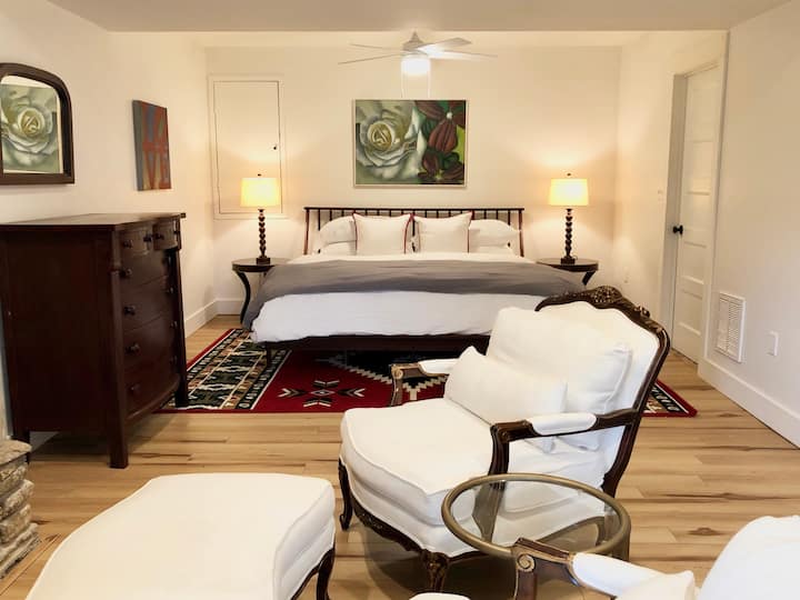 Ground level master bedroom with king bed, sitting area with gas fireplace, ensuite bathroom 