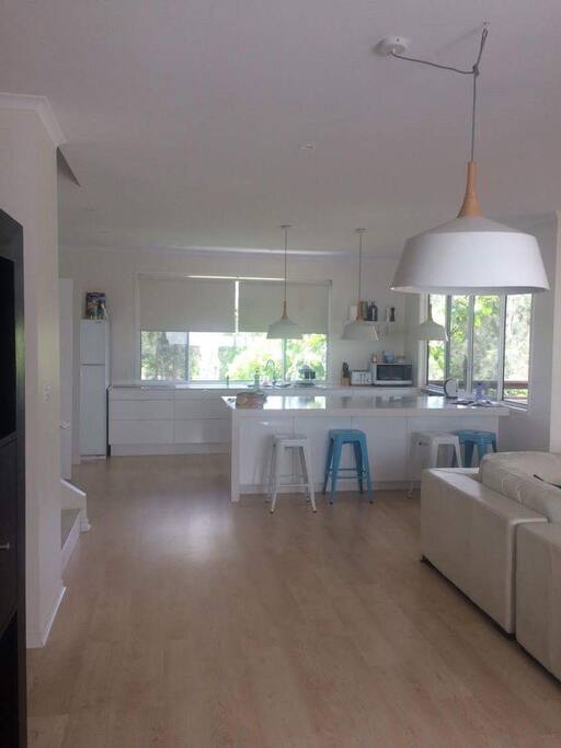 Spacious kitchen area with oven fridge microwave all utensils and dishwasher