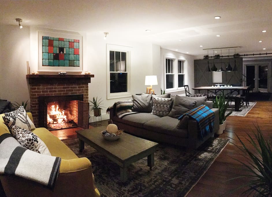 Spacious living room with comfy couches and a working fireplace.