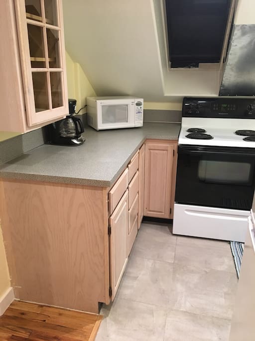 A sweet Kitchenette with everything you need! Coffee maker, microwave, dishes, pots and pans, and coffee, creamer, bagels and cream cheese!