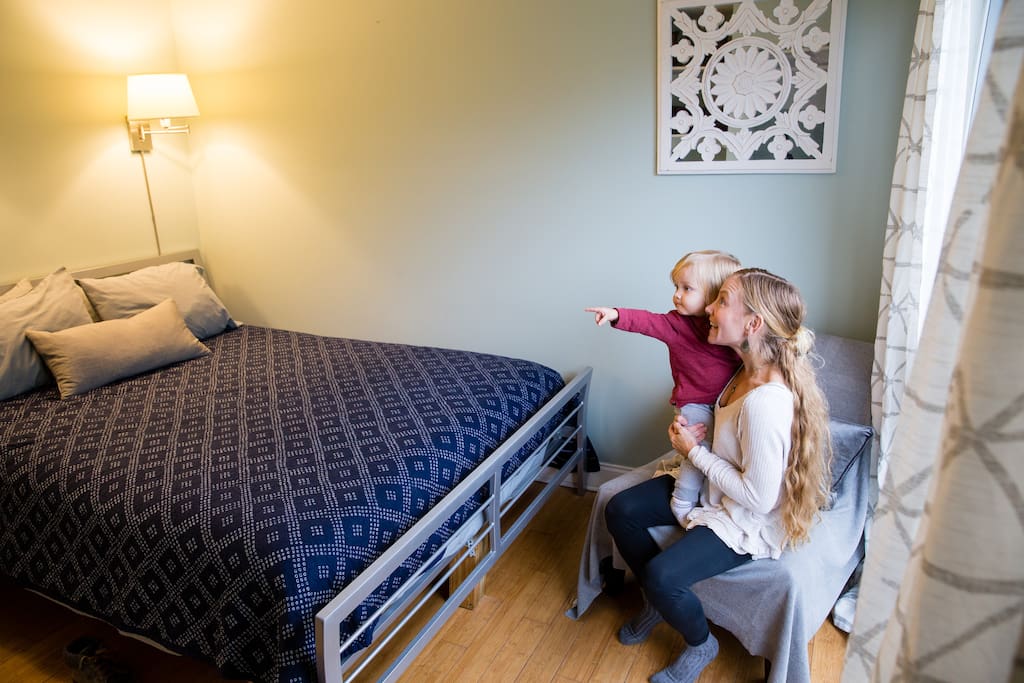 The Bukowski Room has a queen sized bed, built in shelves, a closet for storage and a large window. It's located on the second floor across from the smaller bathroom.